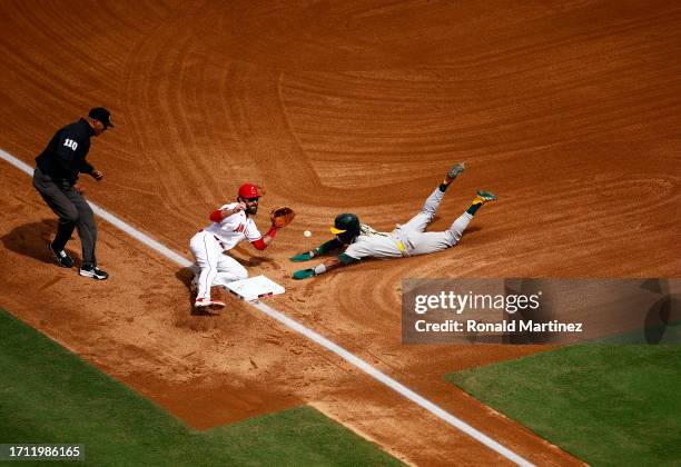 Esteury Ruiz of the Oakland Athletics steals third base against Michael Stefanic of the Los Angeles Angels in the third inning at Angel Stadium of...