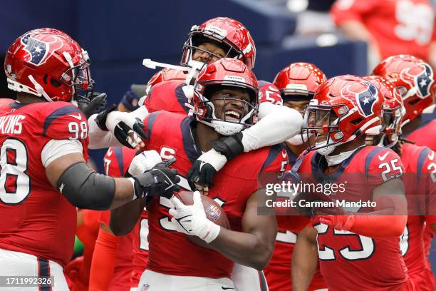 Sheldon Rankins of the Houston Texans, Jonathan Greenard of the Houston Texans and Grayland Arnold of the Houston Texans celebrate with Will Anderson...