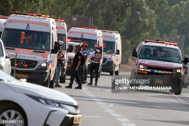 Graphic content / Israeli rescue teams wait next to ambulances parked just outside the southern city of Sderot to evacuate the wounded on October 7...