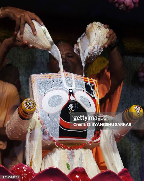 Hindu devotees of International Society for Krishna Consciousness perform rituals as a part of Snana Yatra festival of Lord Jagannath , in Kolkata on...