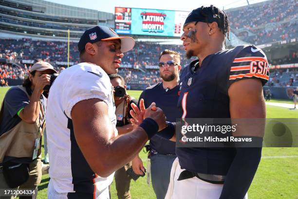 Russell Wilson of the Denver Broncos and Justin Fields of the Chicago Bears shake hands after the game at Soldier Field on October 01, 2023 in...