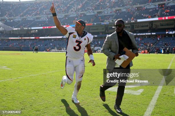 Russell Wilson of the Denver Broncos celebrates as he leaves the field after the game against the Chicago Bears at Soldier Field on October 01, 2023...