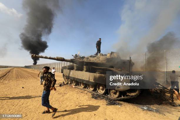 The Al-Qassam Brigades, the armed wing of the Palestinian resistance group Hamas annihilate Israeli tank as smoke rises near Israel-Gaza border in...