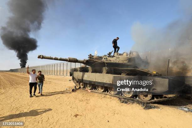 The Al-Qassam Brigades, the armed wing of the Palestinian resistance group Hamas annihilate Israeli tank as smoke rises near Israel-Gaza border in...