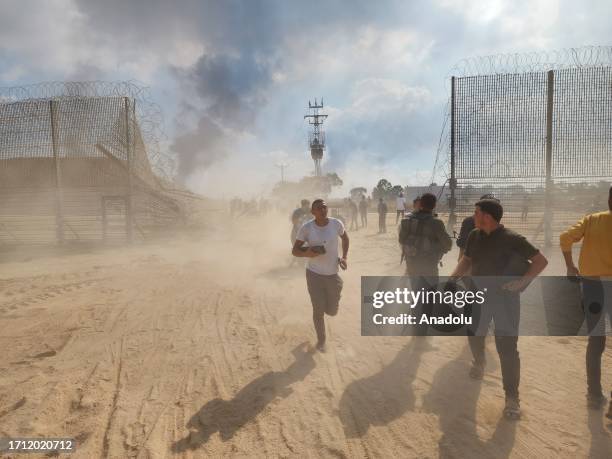 Palestinians take down the fence on the Israel-Gaza border and enter Israel after clashes and attacks in Gaza City, Gaza on October 07, 2023.