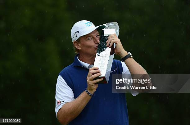 Ernie Els of South Africa poses with the trophy after winning the BMW International Open at Golfclub Munchen Eichenried on a score of -18 under par...