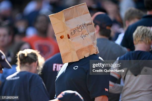 Chicago Bears bears fan stands with a paper bag on his head after the game against the Denver Broncos at Soldier Field on October 01, 2023 in...