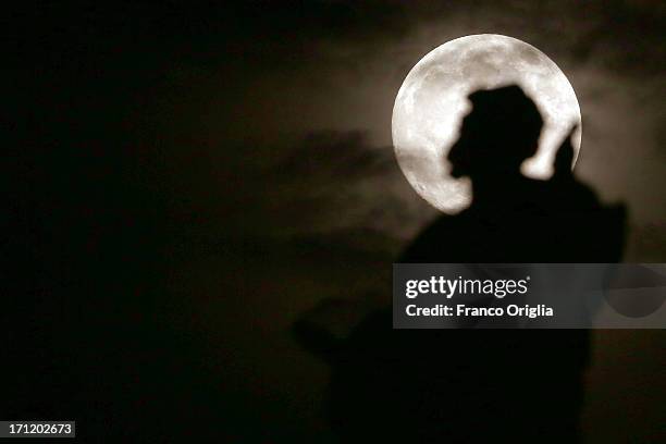 In this picture taken in the night between June 22 and June 23 the moon with a silhouette of the sculpture of the Colonnade overlooking St. Peter's...