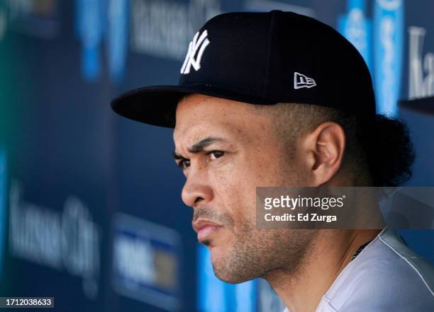 Giancarlo Stanton of the New York Yankees watches from the dugout in the fourth inning against the Kansas City Royals at Kauffman Stadium on October...