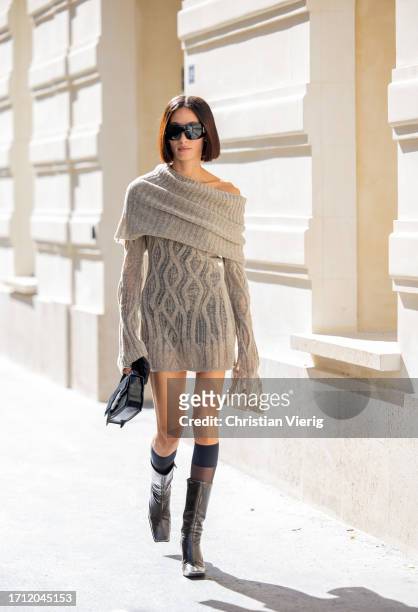 Alexandra Guerain wears grey knit, black bag, knee high socks outside Ottolinger during the Womenswear Spring/Summer 2024 as part of Paris Fashion...