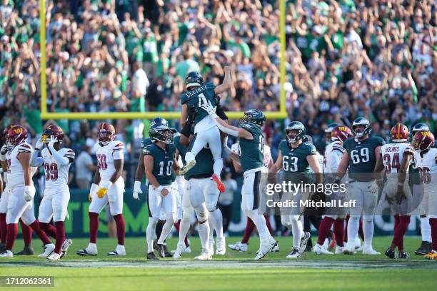 Jake Elliott of the Philadelphia Eagles celebrates kicking the game winning field goal in overtime to defeat the Washington Commanders at Lincoln...