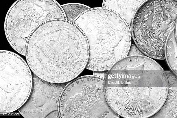 us silver dollars on black background - us penny stock pictures, royalty-free photos & images