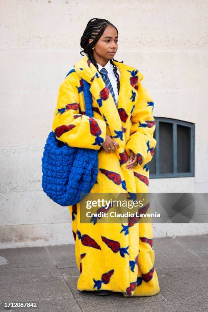 Sarah Monteil wears a yellow carrots printed fur details and blue puffed big bag, outside Giambattista Valli, during the Womenswear Spring/Summer...