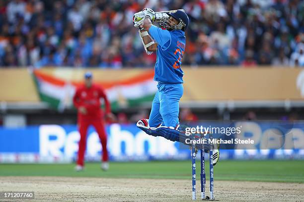 Shikhar Dhawan of India hits a six over backward point off the bowling of Stuart Broad of England during the ICC Champions Trophy Final match between...