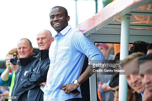 Fabrice Muamba, manager of World Refugee Internally Displaced Persons XI looks on from the dugout during the charity football match between Arsenal...