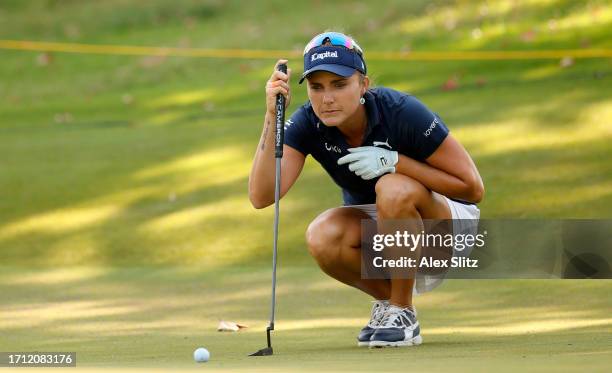 Lexi Thompson of the United States lines up her putt on the 14th hole during the Final round of the Walmart NW Arkansas Championship presented by P&G...