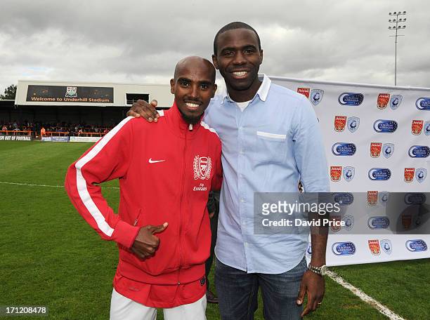 Mo Farah, manager of Arsenal Legends XI and Fabrice Muamba, anager of World Refugee Internally Displaced Persons XI pose together at the charity...