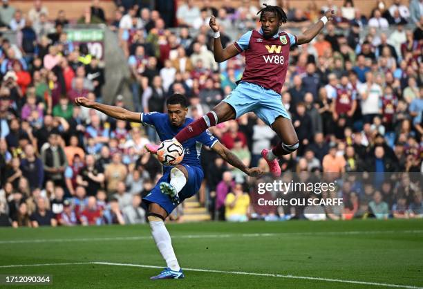 Burnley's Belgian midfielder Mike Tresor jumps above Chelsea's English defender Levi Colwill as he attempts a shot on goal during the English Premier...