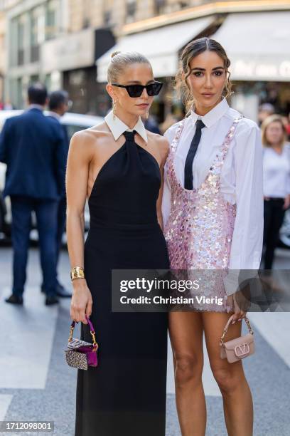 Caroline Caro Daur wears black dress, mini bag & Tamara Kalinic wears white button shirt, tie, pink sequined dress, mini bag, rose heels outside...