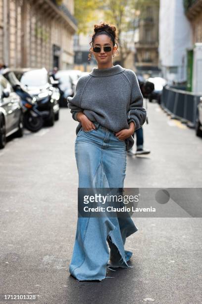 Léna Mahfouf wears a grey jumper and blue long denim skirt, outside Victoria Beckham, during the Womenswear Spring/Summer 2024 as part of Paris...
