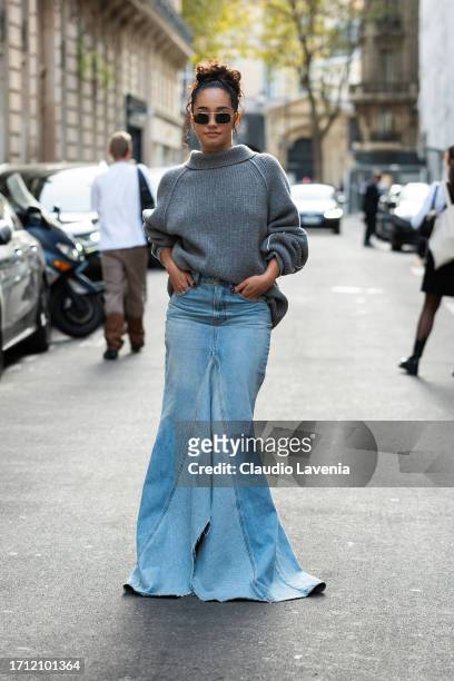 Léna Mahfouf wears a grey jumper and blue long denim skirt, outside Victoria Beckham, during the Womenswear Spring/Summer 2024 as part of Paris...