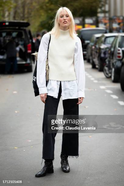 Alayna Neaum wears white shirt, white vest, black jeans and black boots, outside Leonard Paris, during the Womenswear Spring/Summer 2024 as part of...