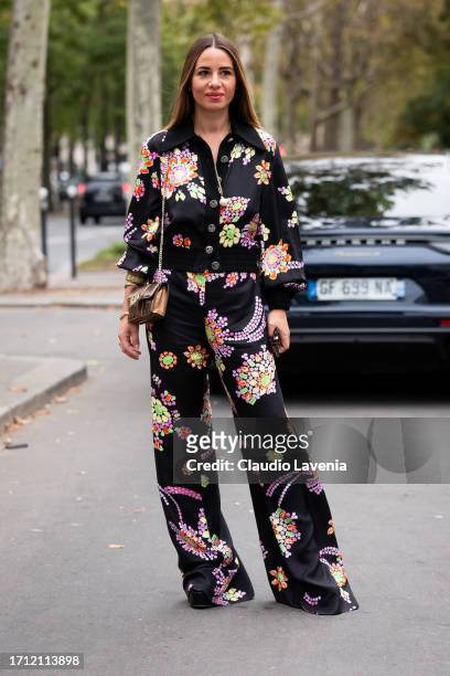Maria Rosaria Rizzo wears a black flower print shirt with matching pant, outside Leonard Paris, during the Womenswear Spring/Summer 2024 as part of...