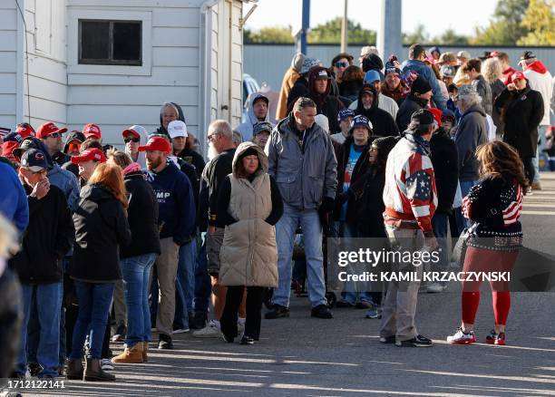 Supporters of former US President and 2024 Presidential hopeful Donald Trump wait in line to hear him speak at a campaign event at the National...