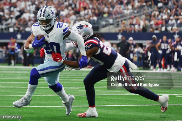 Kyle Dugger of the New England Patriots tackles Tony Pollard of the Dallas Cowboys during the second quarter at AT&T Stadium on October 01, 2023 in...