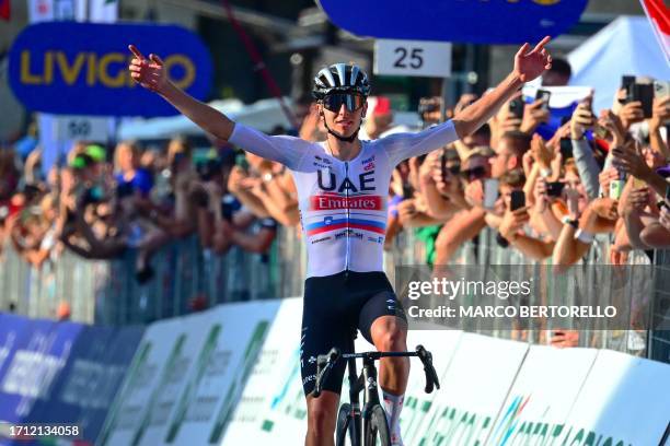 Team Emirates team's Slovenian rider Tadej Pogacar celebrates as he crosses the finish line to win the 117th edition of the Giro di Lombardia , a...