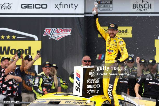 Ryan Blaney, driver of the Menards/Pennzoil Ford, celebrates in victory lane after winning the NASCAR Cup Series YellaWood 500 at Talladega...