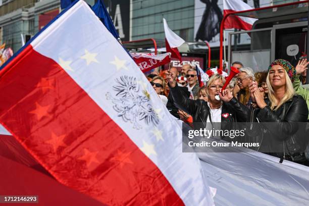 People hold Polish and EU flags during the March of a million Hearts on October 01, 2023 in Warsaw, Poland. Civic Platform, the main opposition party...