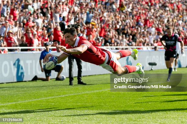 Louis Rees-Zammit of Wales dives over the line to score a try during the Rugby World Cup France 2023 match between Wales and Georgia at Stade de la...