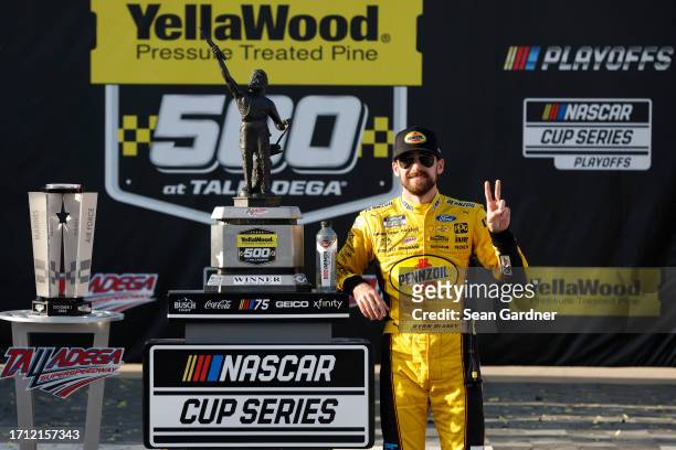 Ryan Blaney, driver of the Menards/Pennzoil Ford, celebrates in victory lane after winning the NASCAR Cup Series YellaWood 500 at Talladega...