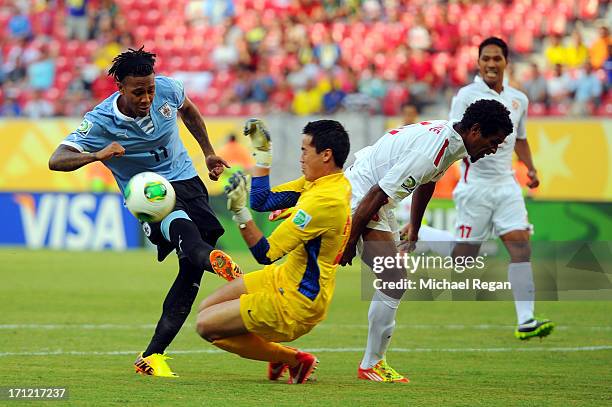 Gilbert Meriel of Tahiti comes out of goal to contest the shot of Abel Hernandez of Uruguay during the FIFA Confederations Cup Brazil 2013 Group B...