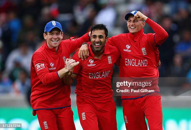 Ravi Bopara of England celebrates with Eoin Morgan and Joe Root after taking the wicket of MS Dhoni of India for no runs after he was caught out by...