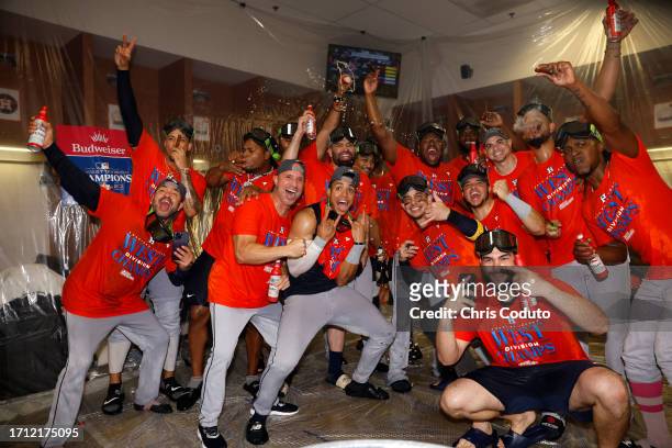 Houston Astros players pose for a photo after defeating the Arizona Diamondbacks 8-1 to win the American League West division title at Chase Field on...