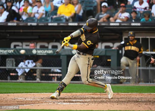 Jurickson Profar of the San Diego Padres hits an RBI single during the eleventh inning against the Chicago White Sox at Guaranteed Rate Field on...