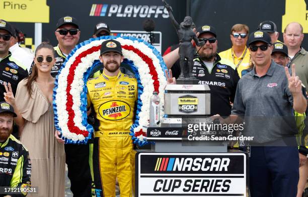 Ryan Blaney, driver of the Menards/Pennzoil Ford, celebrates with Talladega Superspeedway president, Brian Crichton and Gianna Tulio in victory lane...