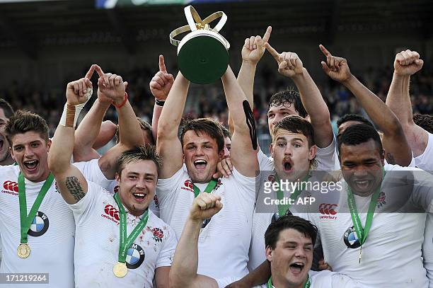 England's captain Jack Clifford holds the trophy with teammates after winning the IRB Junior World Championship final against Wales on June 23 in...