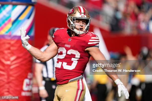 Christian McCaffrey of the San Francisco 49ers celebrates scoring his fourth touchdown on the day against the Arizona Cardinals during the fourth...