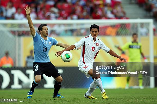 Andres Scotti of Uruguay and Steevy Chong Hue of Tahiti fight for the ball during the FIFA Confederations Cup Brazil 2013 Group B match between...