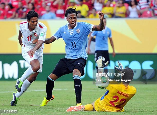 Abel Hernandez of Uruguay scores his third goal of the match against Jonathan Tehau and Gilbert Meriel of Tahiti during the FIFA Confederations Cup...
