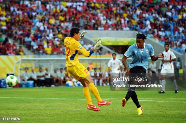 Abel Hernandez of Uruguay scores a goal in the 24th minute against Gilbert Meriel of Tahiti during the FIFA Confederations Cup Brazil 2013 Group B...