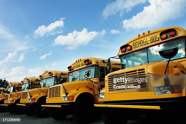 line of school buses - minibuses stock pictures, royalty-free photos & images