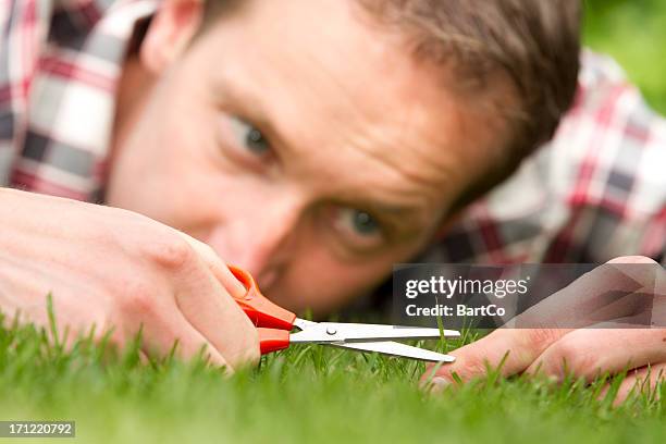 obsessive man laying on grass, perfection - obsessive stockfoto's en -beelden