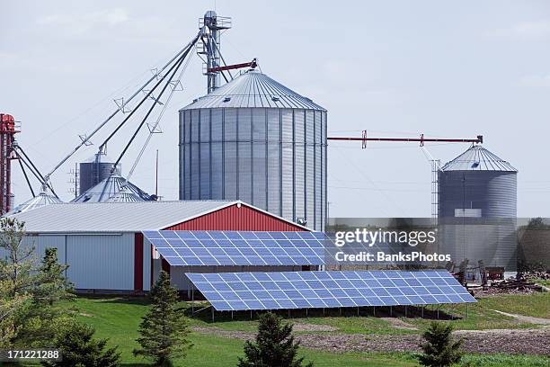 modern farm with grain elevator and solar panels - granary stock pictures, royalty-free photos & images