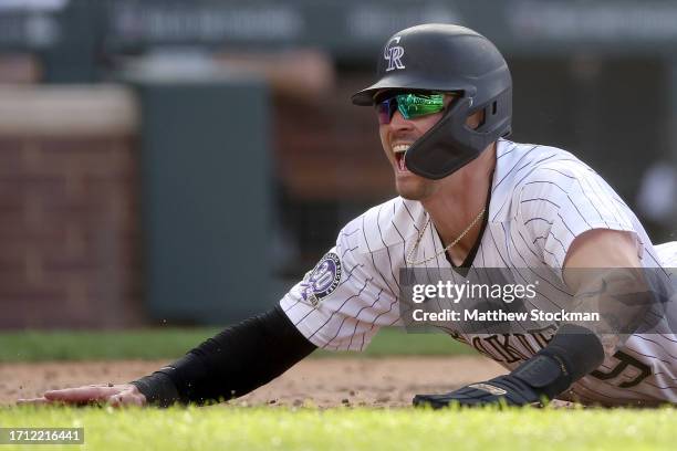 Brenton Doyle of the Colorado Rockies celebrates after scoring the winning run on a wild pitch against the Minnesota Twins in the eleventh inning at...