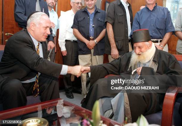 Israeli Prime Minister Benjamin Netanyahu greets 17 September in Jerusalem Rabbi Kadourie, the leading expert on Kabala . Kadourie gave Netanyahu his...