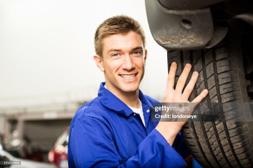 Young Mechanic Changing A Tyre